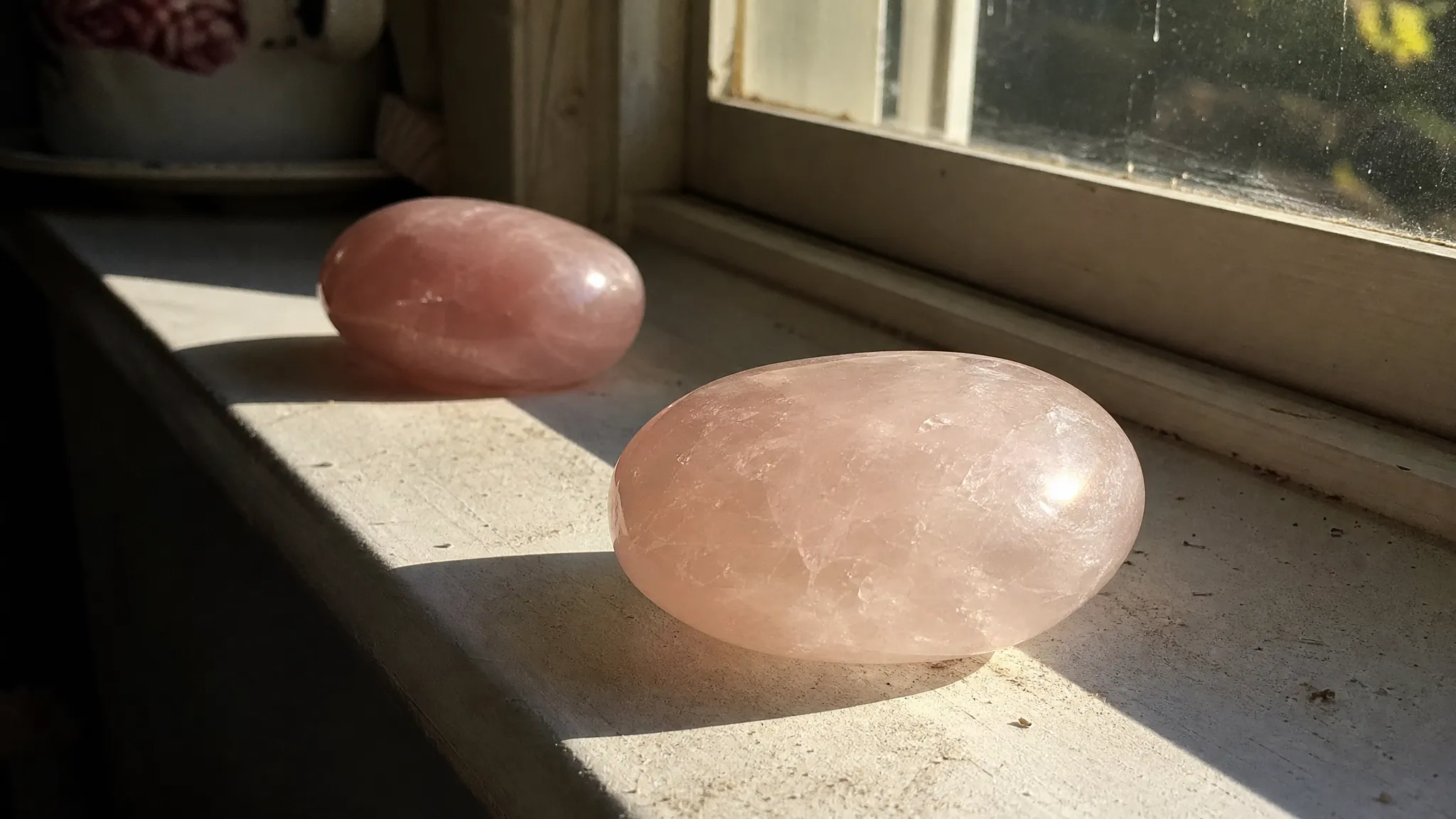 Rose quartz near strong window light showing the practical concern of fading versus ordinary pale color